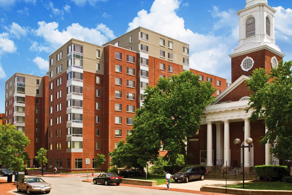 A large building with many windows and trees