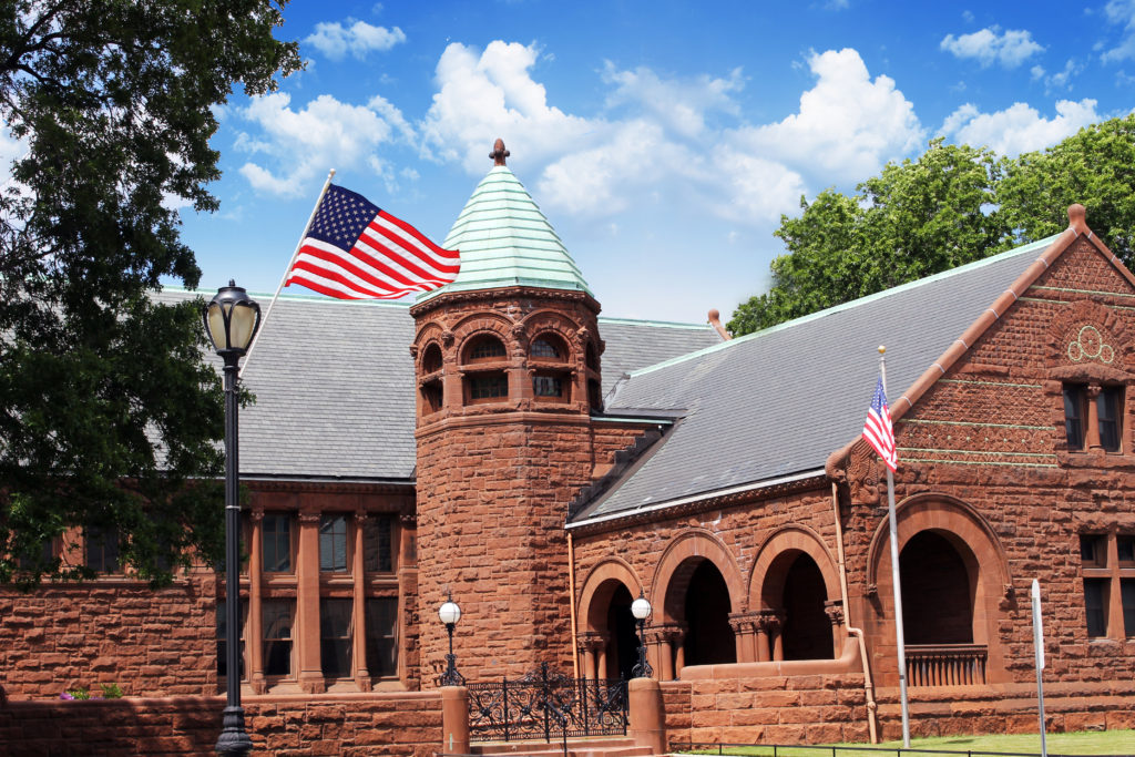 A building with an american flag flying on top of it.