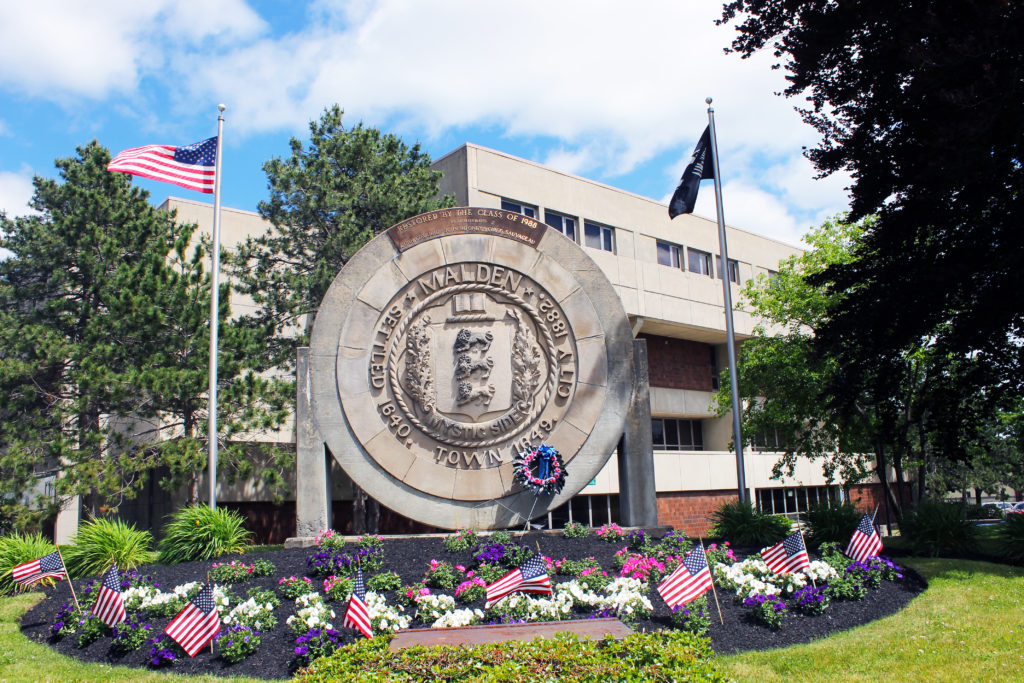 A large building with flowers in front of it.