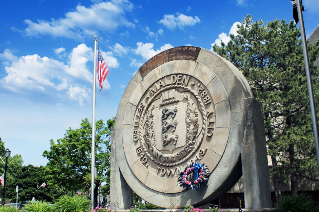 A large stone sign with the seal of the state of california on it.