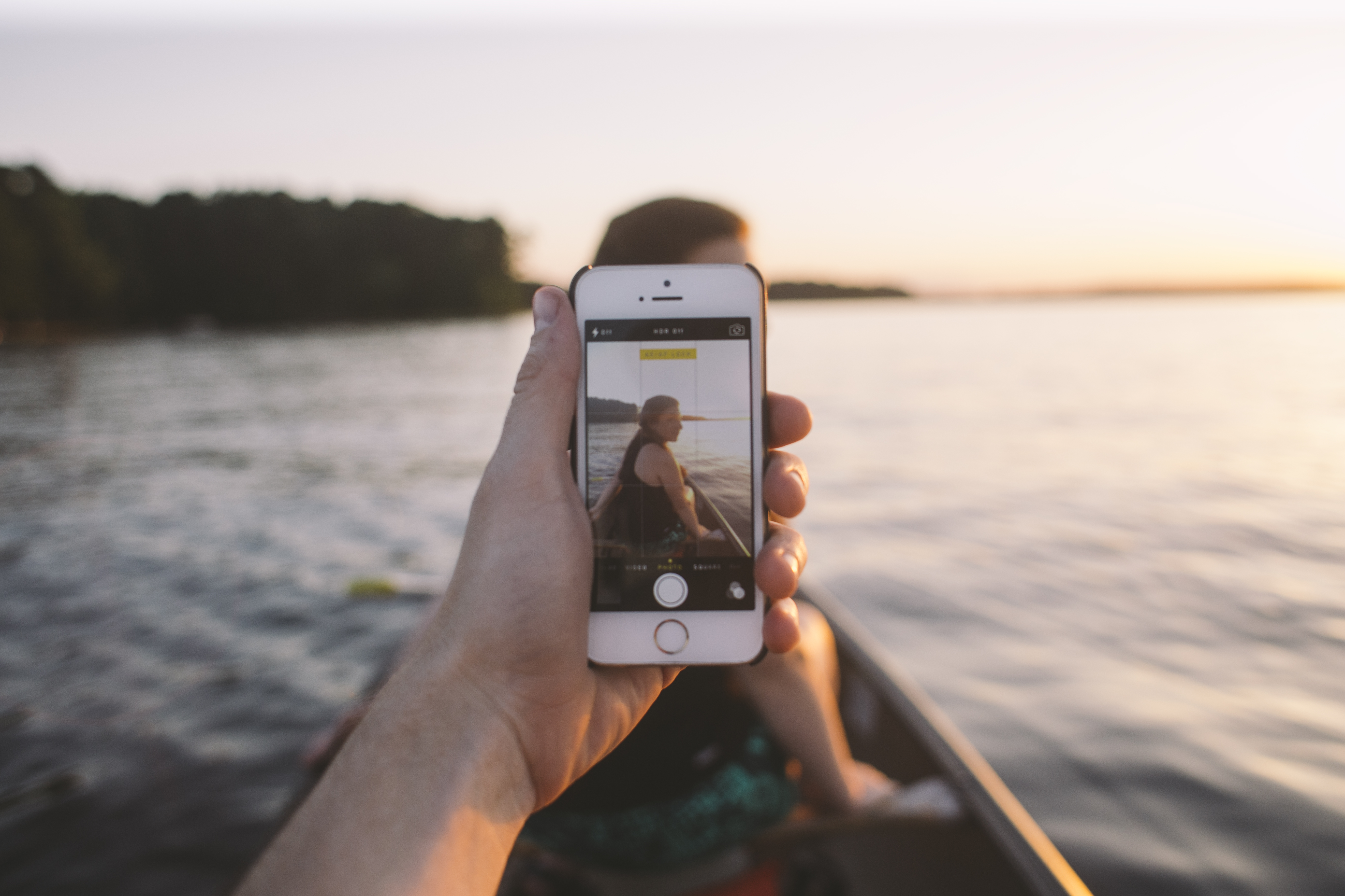 A person taking a picture of themselves in a boat.