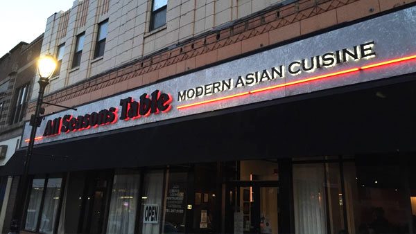 A restaurant sign that says " asian table modern asian cuisine ".