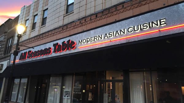 A restaurant sign that says " asian table modern asian cuisine ".
