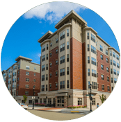 A picture of an apartment building with the sky in the background.