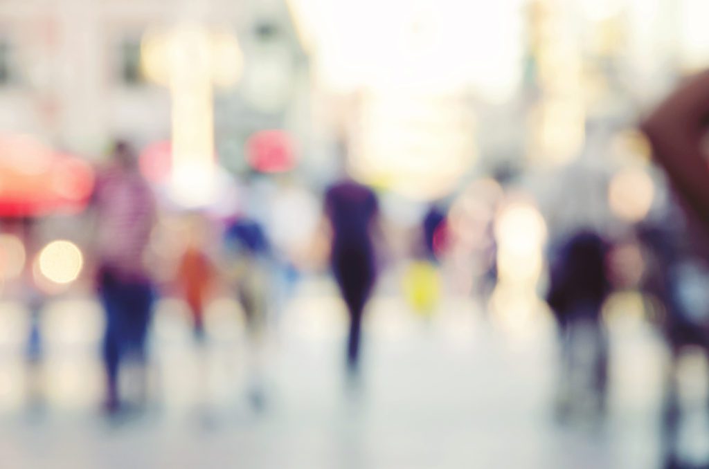 A blurry image of people walking down the street.