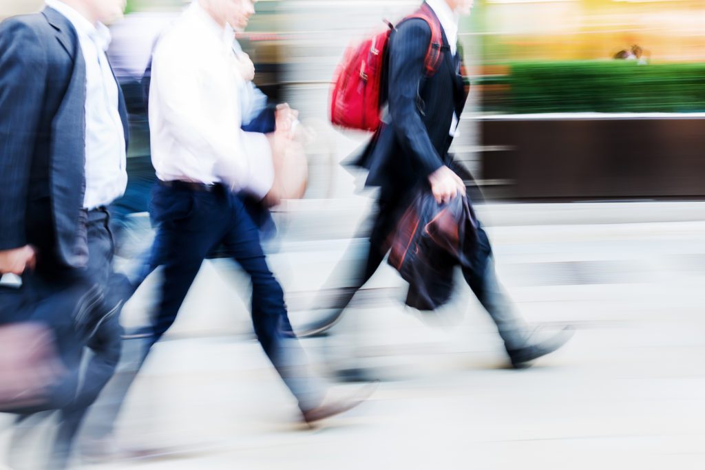 A blurry picture of people walking down the street