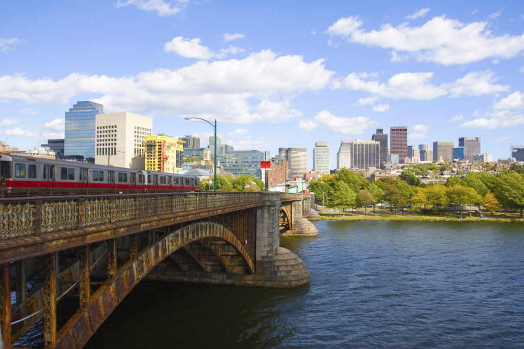 A train is crossing the bridge over the river.
