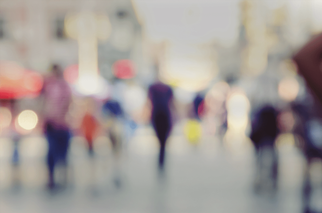 A blurry image of people walking in the street.