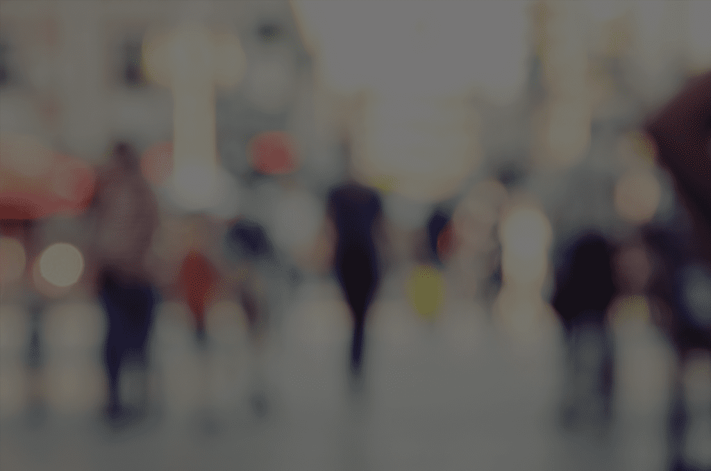 A blurry image of people walking in the street.