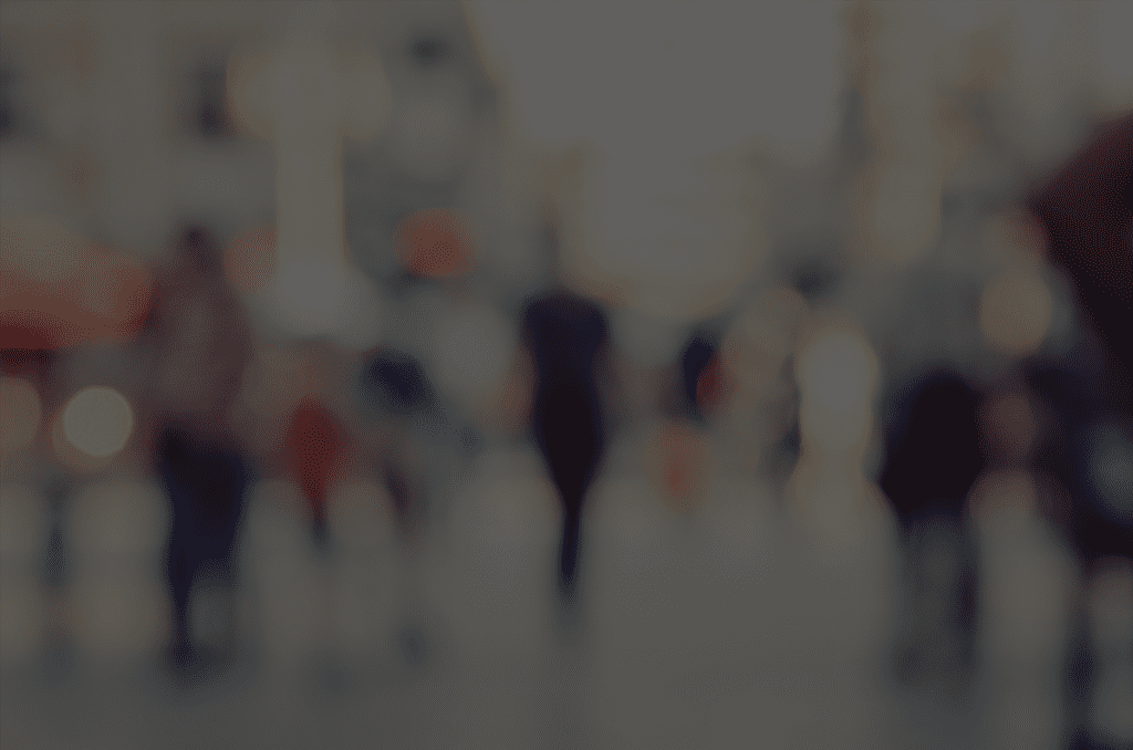 A blurry image of people walking in the street.