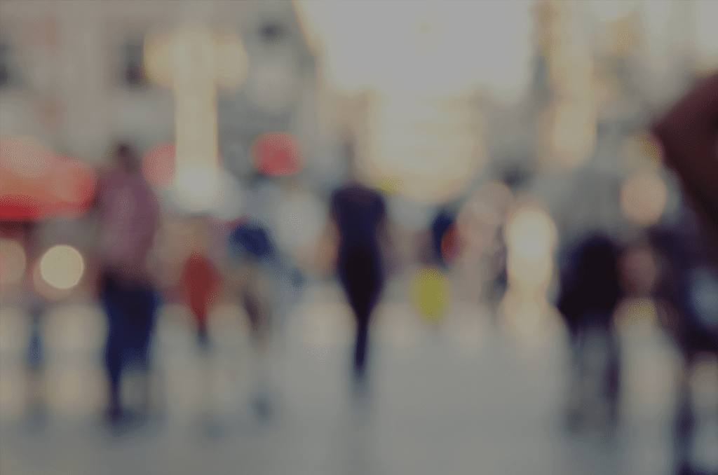 A blurry image of people walking in the street.