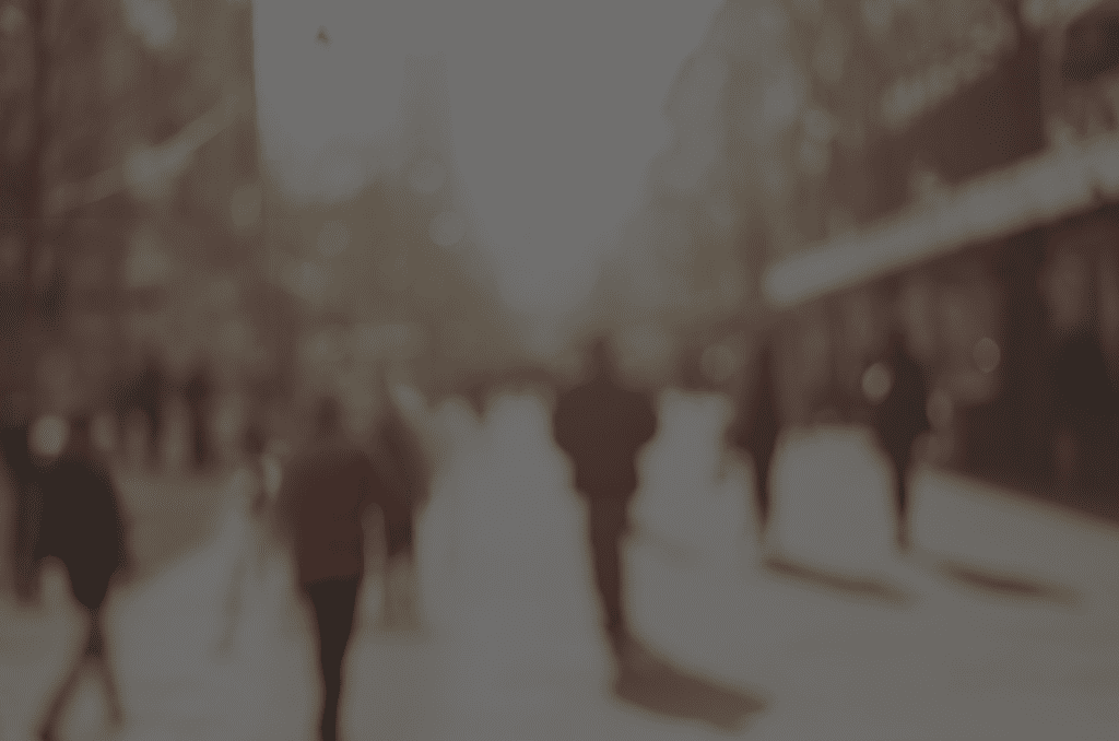 A blurry image of people walking down the street