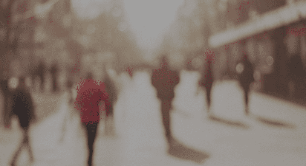A blurry image of people walking down the street
