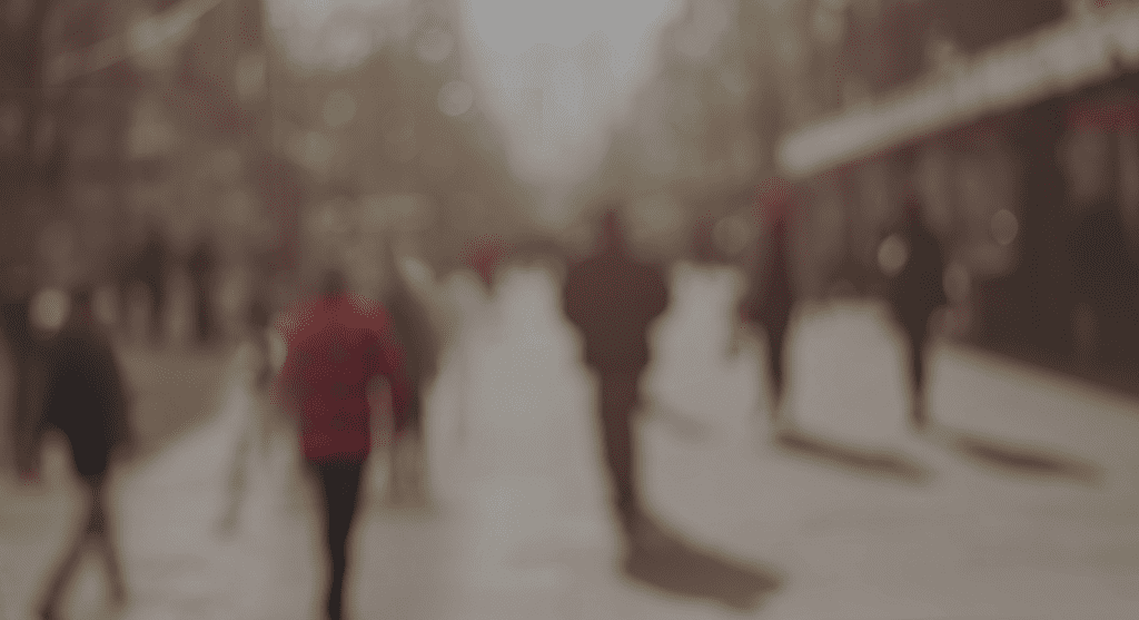 A blurry image of people walking down the street