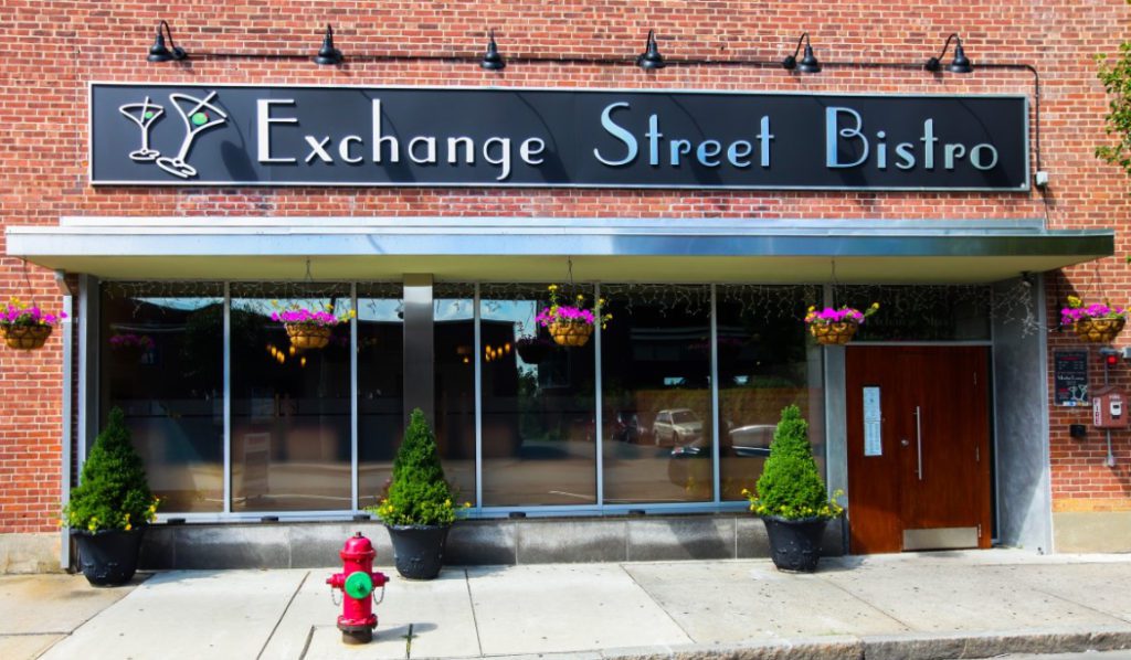 A fire hydrant in front of an exchange street bistro.