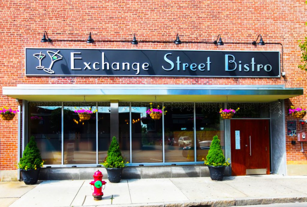 A fire hydrant in front of an exchange street bistro.