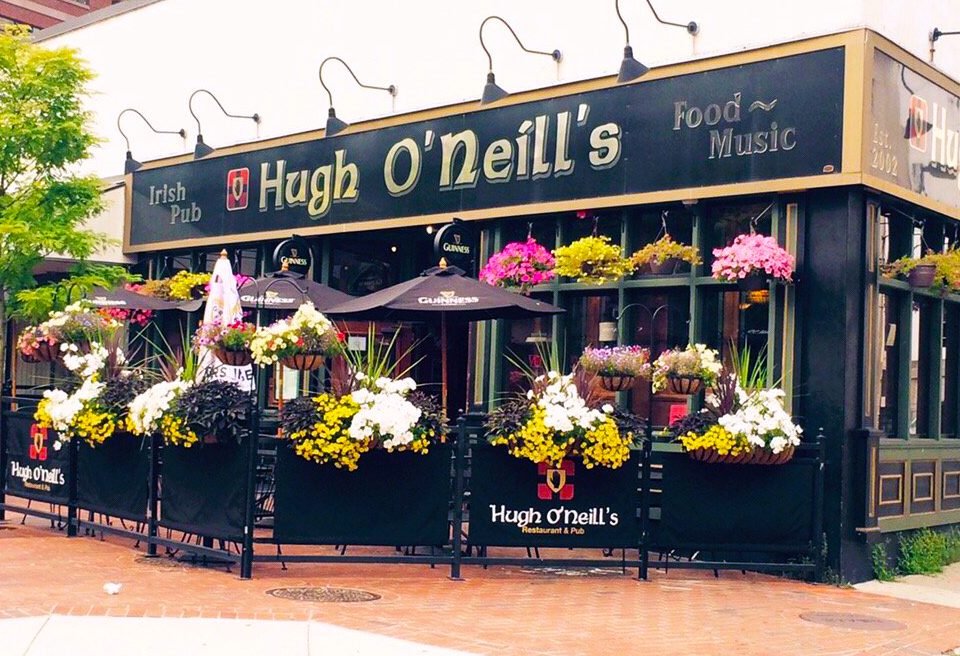 A restaurant with flowers on the outside of it.