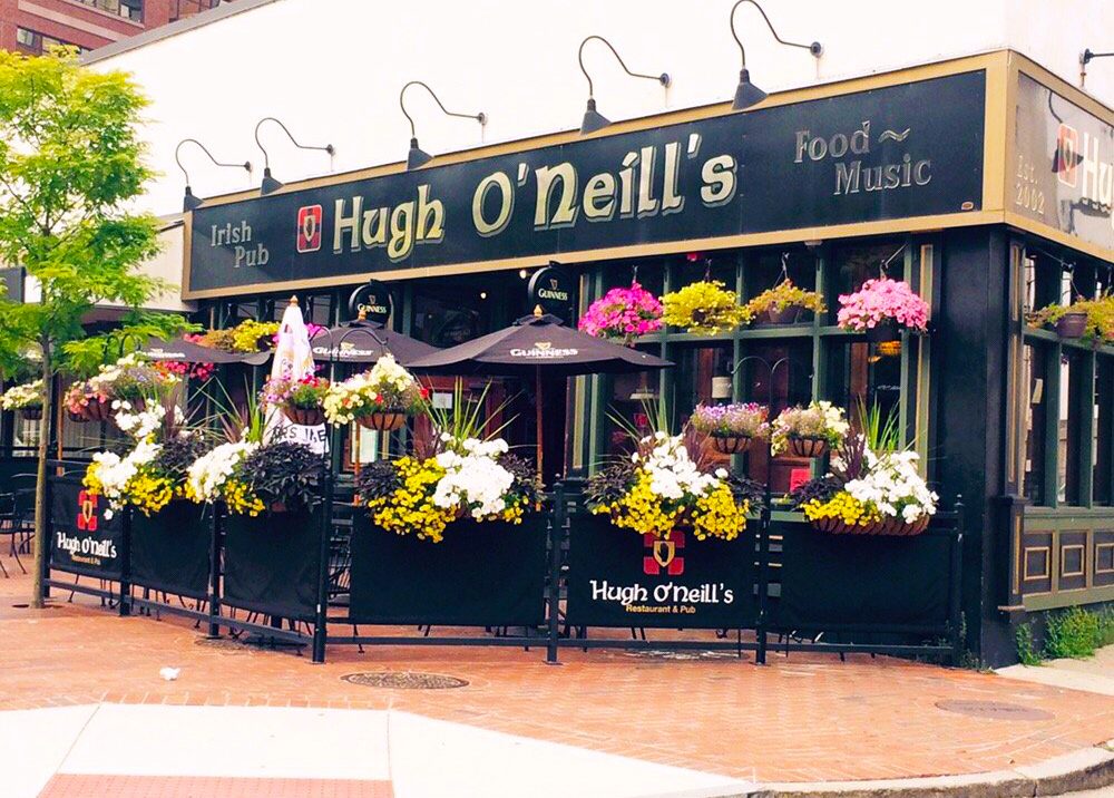 A restaurant with flowers on the outside of it.
