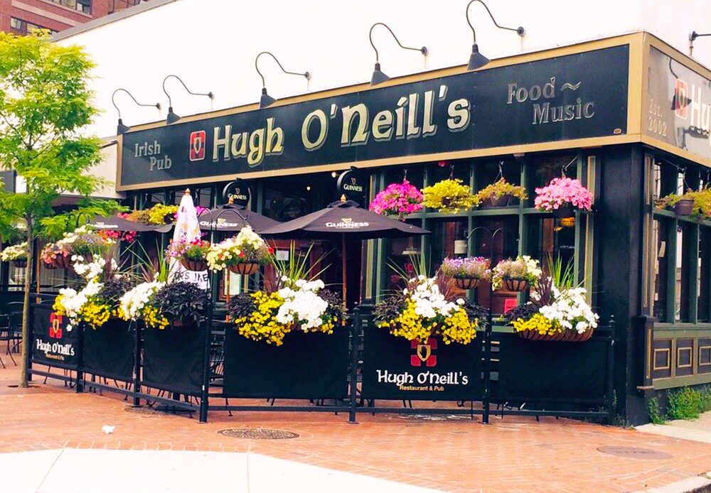 A restaurant with flowers on the outside of it.