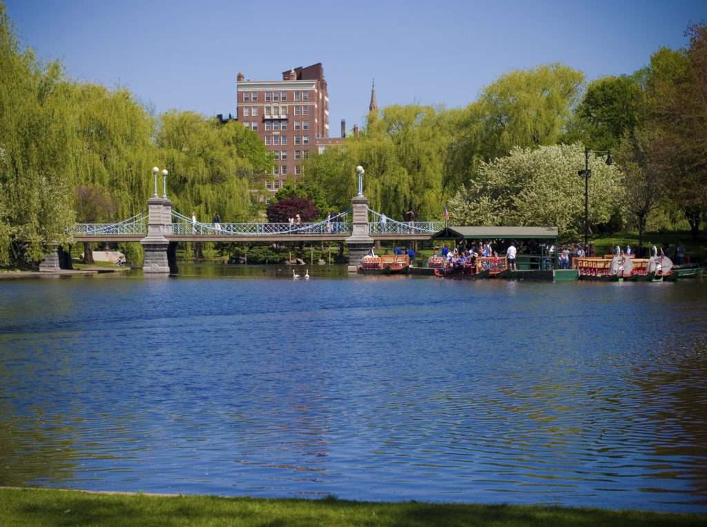 A bridge over the water with boats in it.