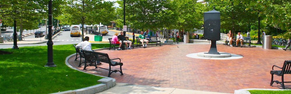 A group of people sitting on top of benches.
