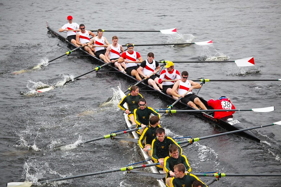 A group of men rowing boats in the water.