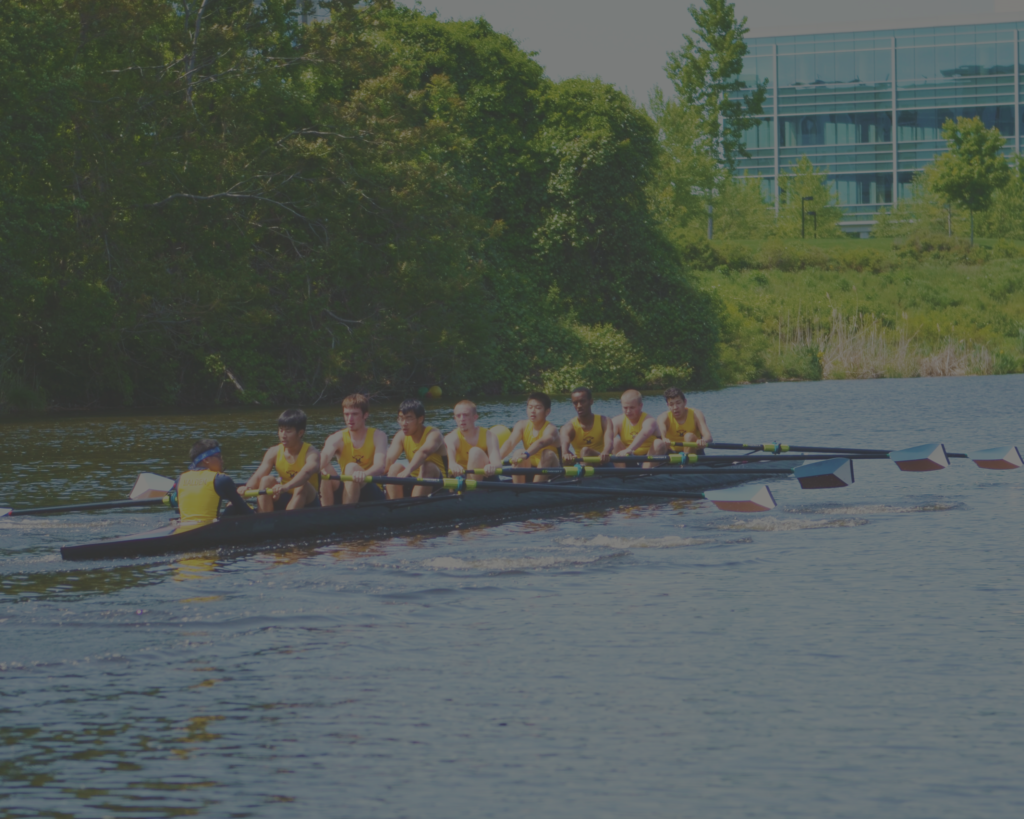 A group of people rowing on the water.