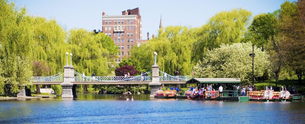 A bridge over the water with people on it.