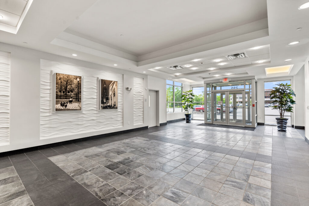 A large lobby with many pictures on the wall.