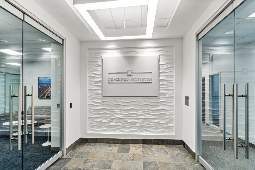 A white wall with waves on it and two doors.