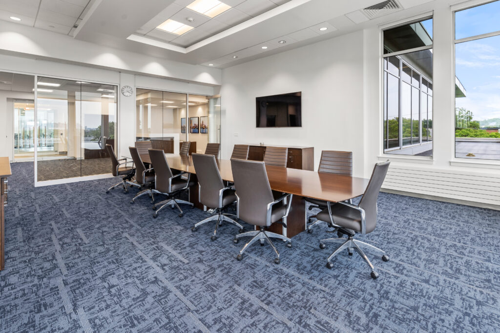 A conference room with a table and chairs
