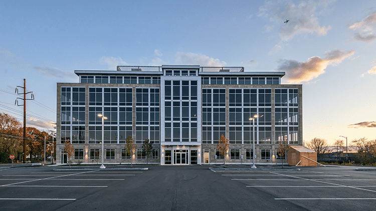 A large building with many windows and lights.