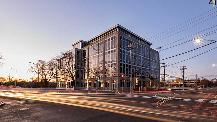 A building with many windows and lights on the side of it